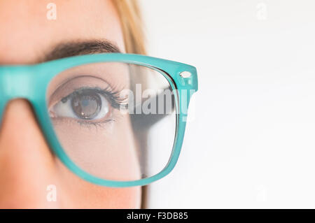 Portrait of young woman wearing eyeglasses in studio