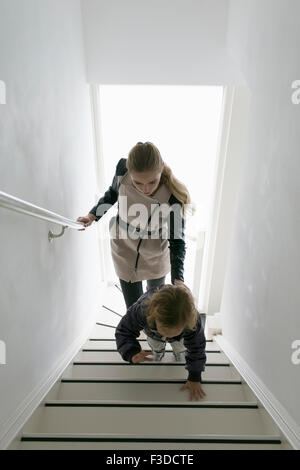 Mère et fils (4-5) en montant un escalier Banque D'Images