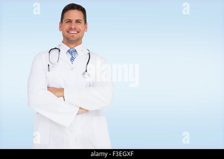 Image composite de handsome doctor with arms crossed Banque D'Images