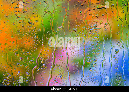 Gouttes de pluie sur la fenêtre en verre donnant sur la frontière le jardin en été Banque D'Images