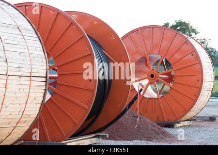 3 grosse orange métal et bois batterie câble industriel sur un site qui relie un parc éolien offshore au réseau électrique national du Royaume-Uni. Banque D'Images