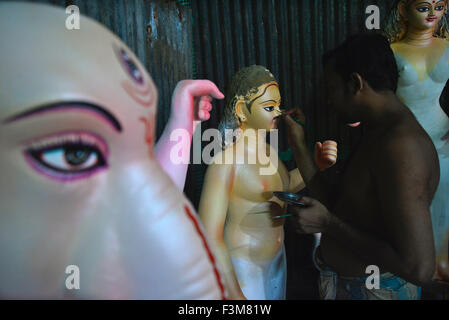 L'artiste est occupé à décorer les yeux de l'argile, idole de la Déesse Durga Puja Durga pour le prochain festival à Dhaka, Bangladesh. Le 9 octobre 2015 les gens du Bangladesh ont été vus les préparatifs de la fête de Durga Puja à Dhaka. La fête hindoue, qui célèbre la déesse Durga Puja, est célébré chaque année dans différentes parties du Bangladesh ainsi que les états indiens. Banque D'Images