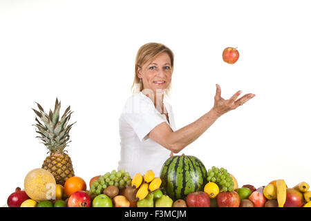 De nombreux fruits empilés et cute woman Banque D'Images