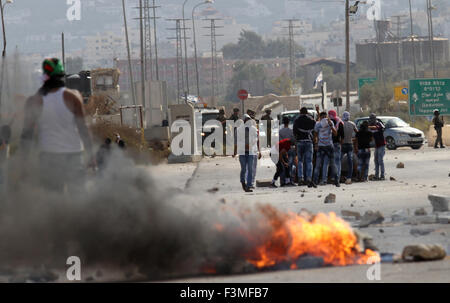 Naplouse, Cisjordanie, territoire palestinien. 9 octobre, 2015. Des manifestants palestiniens lancent des pierres vers les forces de sécurité israéliennes au cours d'affrontements à l'Howara contrôle près de la ville cisjordanienne de Naplouse, le 9 octobre 2015. Tension et de protestations ont augmenté après un israélien le 09 octobre poignardé quatre Palestiniens dans le sud d'Israël, dans ce qui est considéré comme une attaque de vengeance, ont dit. Le 08 octobre plusieurs incidents violents s'est produit, y compris à l'arme blanche qui a fait huit blessés israéliens, un Palestinien a été tué à Jérusalem-Est dans des affrontements avec l'armée tandis qu'au moins six ont été blessés sur le We Banque D'Images