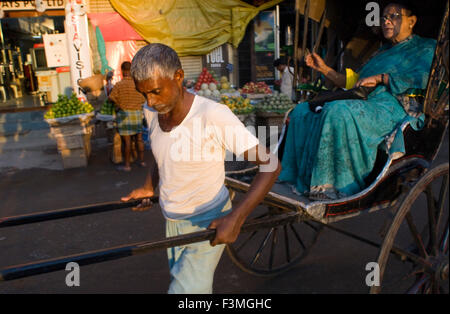 Kolkata, Bengale occidental, Inde. Derniers jours du pousse-pousse. Kolkata est plié sur son image moderne de brunissage et de l'interdiction d'un puissant symbole de l'Inde a passé colonial. La stratégie des drivers à Kolkata-chauffeurs de véhicules privés et les taxis et les autobus et les scooters à trois roues utilisé comme jitneys et même cyclo-est simple : aller de l'avant tout en klaxonnant. Il n'y a pas de panneaux d'arrêt à parler de. À un visiteur, les signes qui disent, en grande imprimerie, obéir à des règles de circulation par hasard comme un peu d'humour noir. Banque D'Images