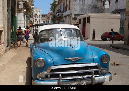 Cuba La Havane blue American car Old Timer Scène de rue à La Havane centre ville samedi après-midi vêtements sur balcon Banque D'Images
