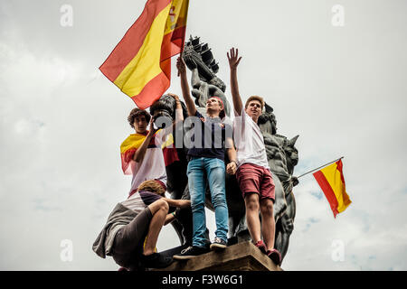 Barcelone, Espagne. 12 octobre, 2015. Jeunes manifestants avec leurs drapeaux ont grimpé sur une statue à Barcelone, Catalogne Suqare au cours d'une manifestation contre l'indépendance catalane : Crédit matthi/Alamy Live News Banque D'Images
