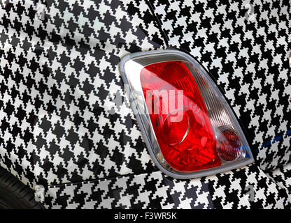 Une Fiat 500 Abarth enveloppé dans dent chien vinyle vérifier lors de l'ouverture du nouveau siège de Garage Italia la douane dans Milan. Banque D'Images