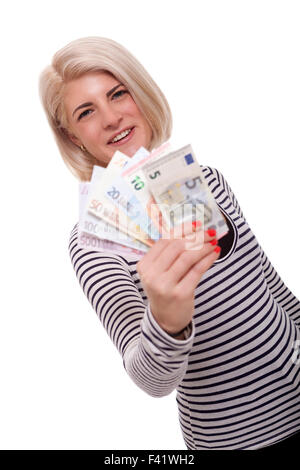 Attractive smiling blonde woman holding up une poignée de billets en éventail de différentes dénominations, angle incliné conceptual image isolated on white Banque D'Images