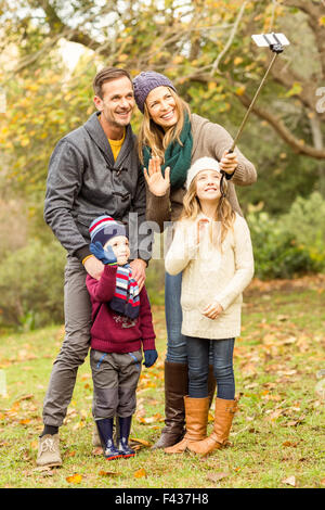 Smiling young family taking autoportraits Banque D'Images