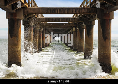 Vagues se briser sous la jetée à Swakopmund, Namibie Banque D'Images