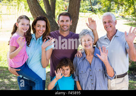 Extended family smiling in the park Banque D'Images