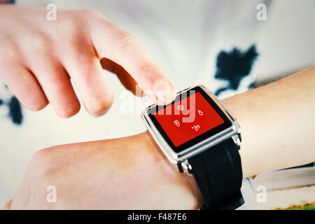 Composite image of woman using smartwatch Banque D'Images