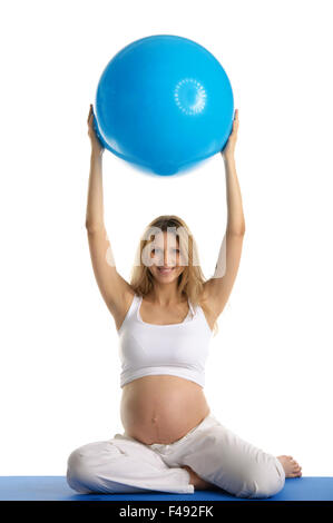 Pregnant woman practicing yoga with ball Banque D'Images