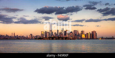 Gratte-ciel de Manhattan, le quartier financier et Ellis Island Panorama au coucher du soleil, New York City, USA Banque D'Images