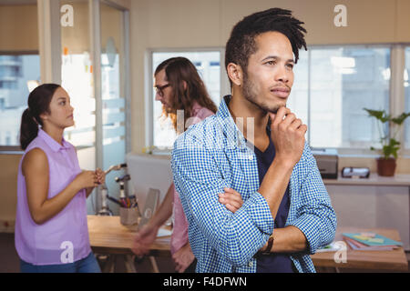 Thoughtful creative businessman standing in office Banque D'Images