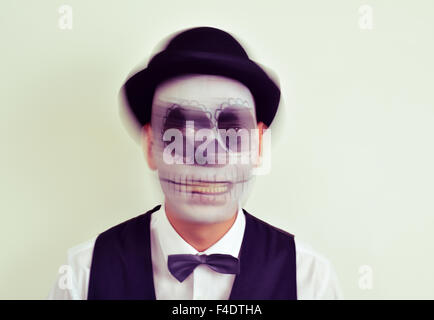 Portrait d'un homme avec le maquillage, le port de calaveras noeud papillon et chapeau melon, in motion Banque D'Images