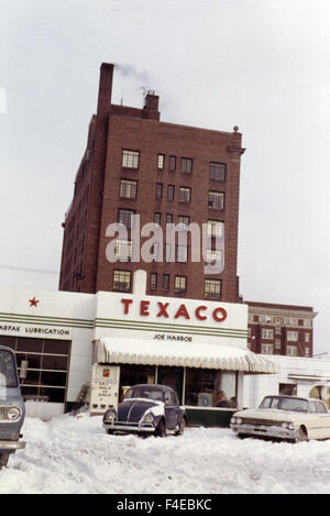 La station service Texaco. Voiture VW, recouvert de neige. voyageant par train Amtrak aux États-Unis au début des années 1960. transport Banque D'Images