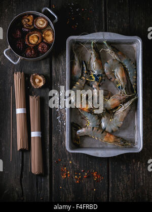 Ingrédients pour le dîner d'Asie Soba non cuit, tremper les champignons shiitake et les crevettes plus ancienne en bois avec un sel d'arrière-plan Banque D'Images