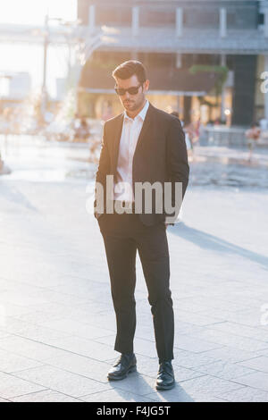 Jeune beau black hair businessman moderne dans la ville de rétro-éclairage, à la réussite de l'entreprise, à la baisse -, concept de travail Banque D'Images