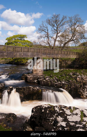 River Wharfe courant (vitesse d'obturation lente vue) sous la passerelle & ciel bleu ensoleillé - scenic Linton Falls Cascade, Skipton, Yorkshire, Angleterre, Royaume-Uni. Banque D'Images