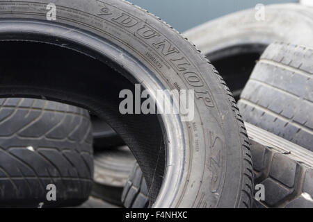 Pneu Dunlop usés importante dans une pile de pneus usés faisant l'objet d'un véhicule commercial. Banque D'Images