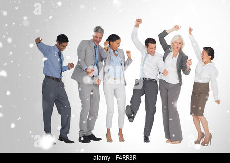 Image composite des gens d'affaires cheering in office Banque D'Images