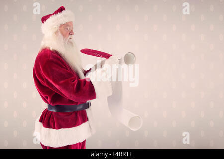 Image composite d'un père noël écrit la liste Banque D'Images