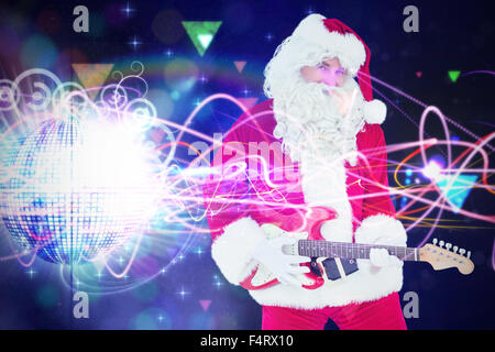 Image composite de santa claus joue de la guitare avec des lunettes Banque D'Images