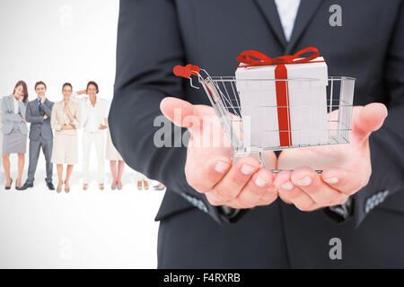 Composite image of businessman holding ses mains Banque D'Images