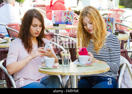 Deux jeunes femme avec leurs nouveaux téléphones intelligents Banque D'Images