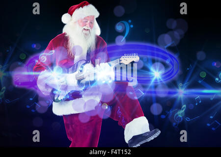 Image composite du père Noël a l'amusement avec une guitare Banque D'Images