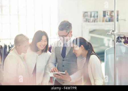 Fashion Designers sharing digital tablet in office Banque D'Images