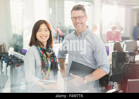 Portrait of smiling fashion designers in office Banque D'Images