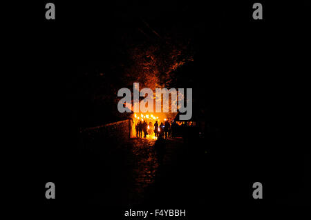 Pour célébrer le 5e novembre, également connu sous le nom de feu de nuit, des membres d'une société d'un feu de transporter des torches enflammées dans une procession aux flambeaux à travers les rues de Firle un petit village dans l'East Sussex, Angleterre. Banque D'Images