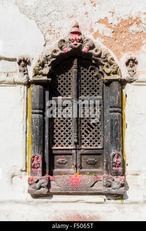 Fenêtre en bois joliment sculpté d'un petit sanctuaire dans les collines au-dessus du temple de Pashupatinath Banque D'Images