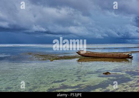 L'île de Kiriwina Pirogue dans les eaux peu profondes près de la petite île tropicale Banque D'Images