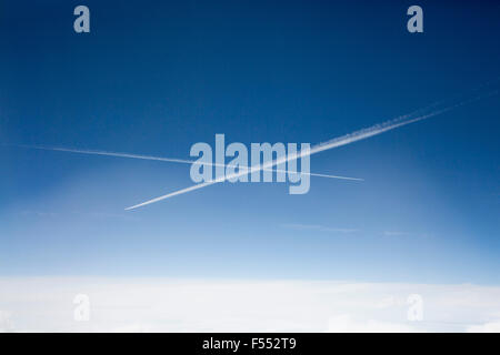 Low angle view of des traînées de vapeur dans le ciel bleu Banque D'Images