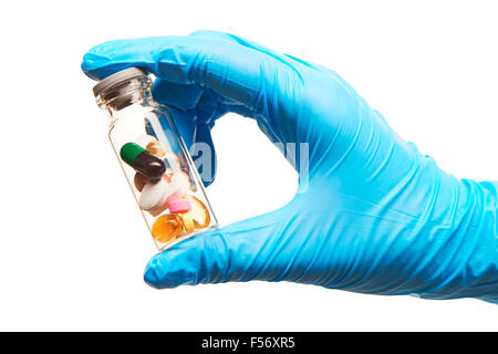 Close up de la main du médecin en bleu les gants chirurgicaux stérilisés ampoule en verre blanc transparent holding remplie avec différents Banque D'Images