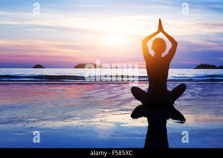 Arrière-plan de yoga, abstract silhouette de femme méditant sur la plage Banque D'Images