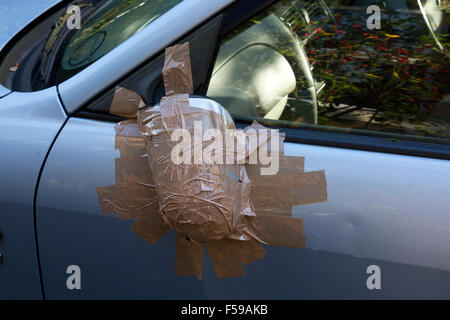 Voiture endommagée wing mirror qui a eu lieu le avec du ruban gommé Banque D'Images