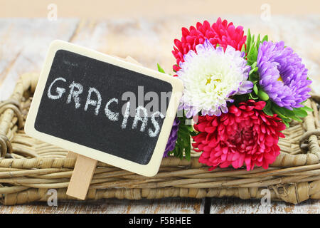 Gracias (ce qui signifie merci en espagnol) écrit sur tableau noir miniature et colorée de fleurs bouquet de fleurs de l'aster Banque D'Images