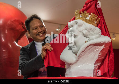 Londres, Royaume-Uni. 09Th Nov, 2015. Chen Dapeng dévoile un nouveau buste de Sa Majesté la Reine Elizabeth II, qu'il a exécuté pour célébrer l'année 2015 UK-Chine d'échange culturel (c'est sur un stand avec ses millions de livres d'autres œuvres). Olympia hiver Art & Antiques Fair- dans sa 25e année, le salon accueillera 22 000 visiteurs qui viennent voir plus de 30 000 pièces pour la vente de la 120 concessionnaires triés sur le frpom d'une valeur de £100-£1m. La foire est 2-8 novembre 2015, avec l'ouverture de la réception d'aperçu le 2 novembre à 5h00.. Crédit : Guy Bell/Alamy Live News Banque D'Images