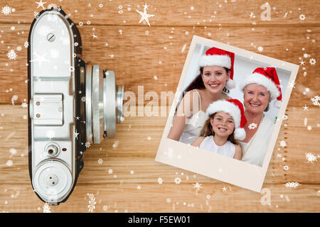 Image composite de fille, mère et grand-mère baking christmas sweets Banque D'Images