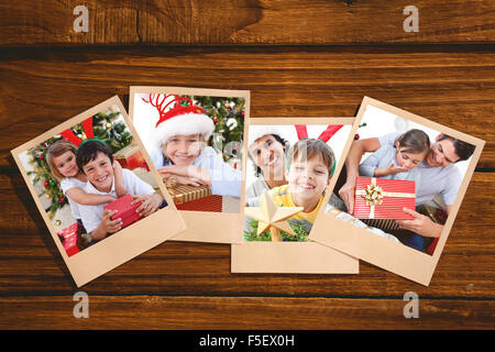 Composite image petite fille de l'ouverture d'un cadeau de Noël avec son père Banque D'Images