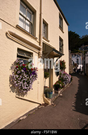 Voir le Warren Cornwall Polperro England UK avec une maison ornée de pétunia rempli paniers suspendus Banque D'Images