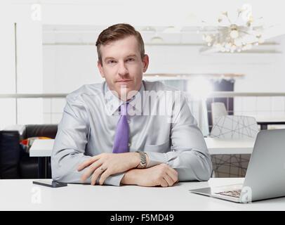 Portrait of Mid adult businessman sitting at desk