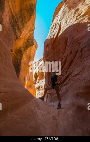 Une femme admire la lumière chaude dans le Ravin de Peekaboo Escalante Canyons de Grand Staircase Escalante National Monument (Utah). Banque D'Images