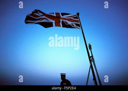 AJAXNETPHOTO.(OMA-83).L'OMAN. 5 OCT 2001. Un marin solitaire ATTEND L'ORDRE DE GRÈVE LES COULEURS SUR LE HMS FEARLESS AU COUCHER DU SOLEIL AU LARGE DE LA CÔTE D'OMAN. PHOTO:JONATHAN EASTLAND/AJAX. REF:CDS03 19 Banque D'Images