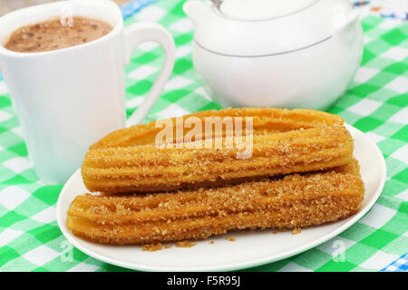 Churros espagnol sur la plaque avec une tasse de chocolat chaud Banque D'Images